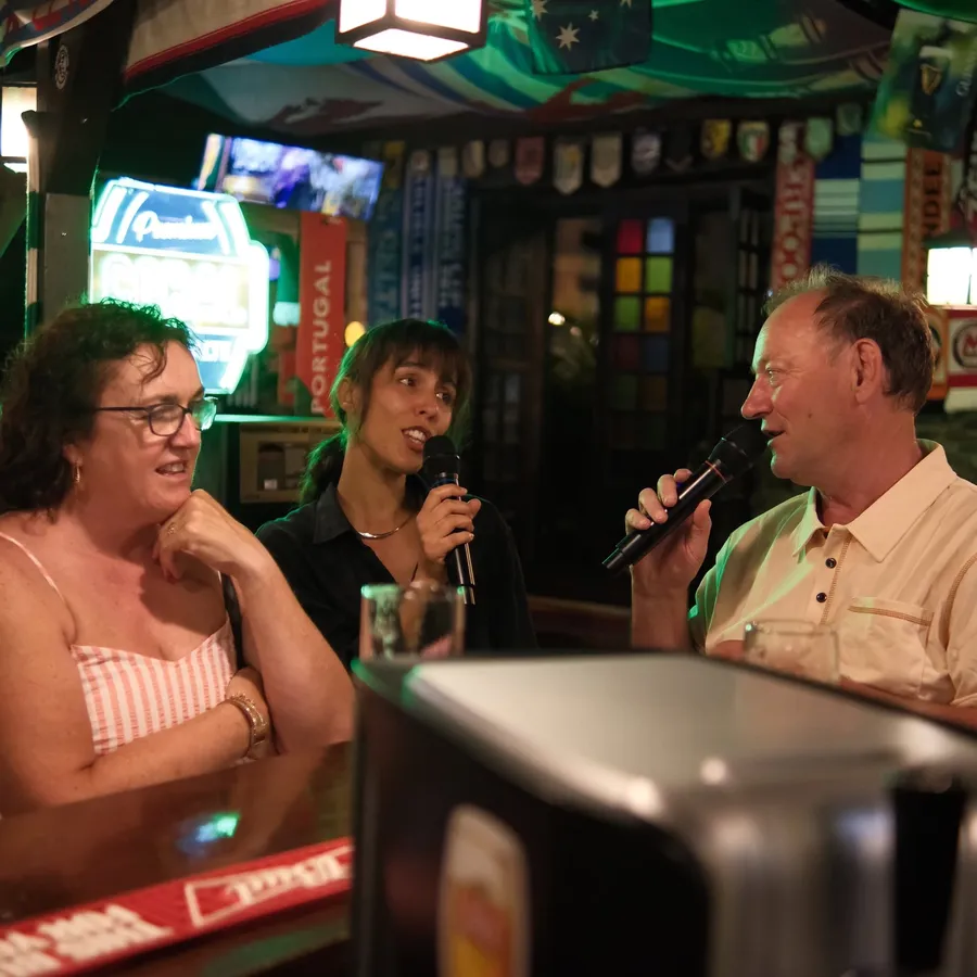 Friends taking the microphone during an evening at Local Pub